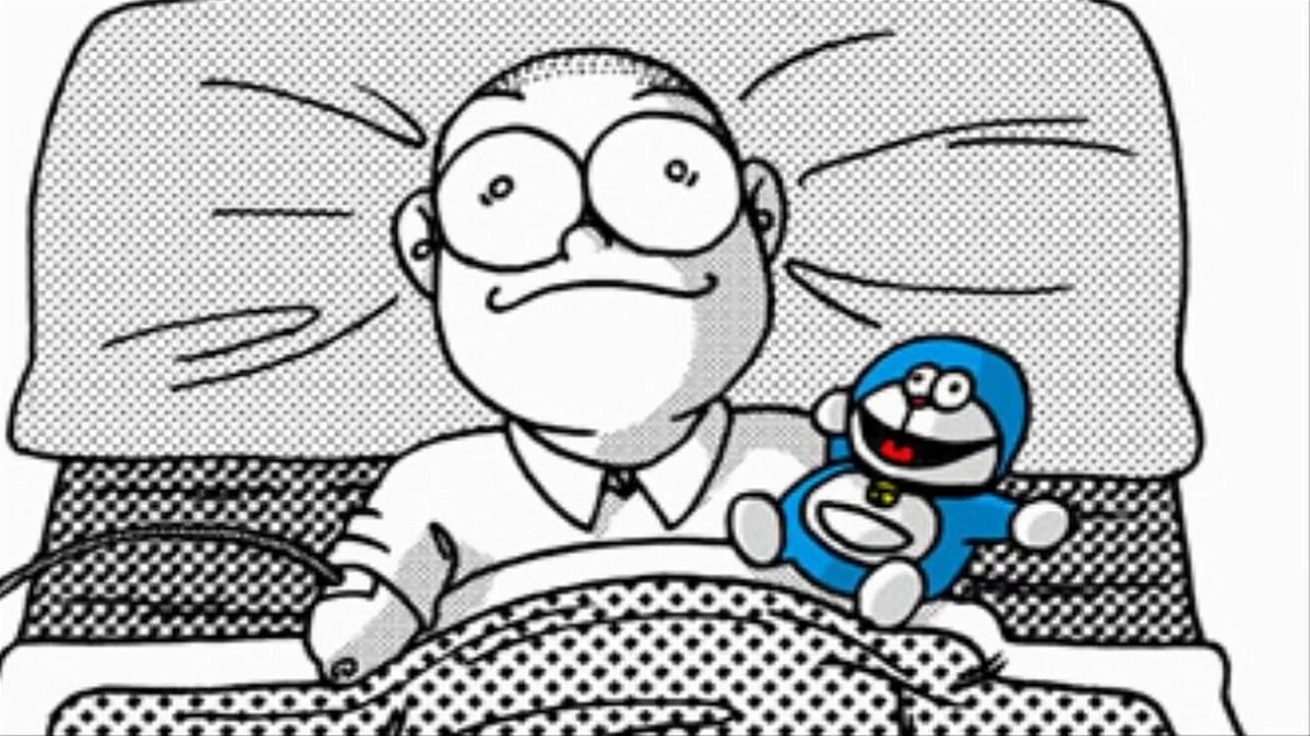 Nobita con accanto il pupazzo di Doraemon