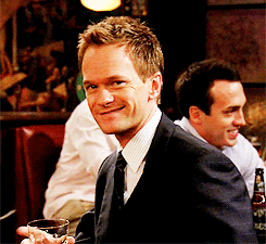 Barney di How I Met Your Mother con in mano l'immancabile drink