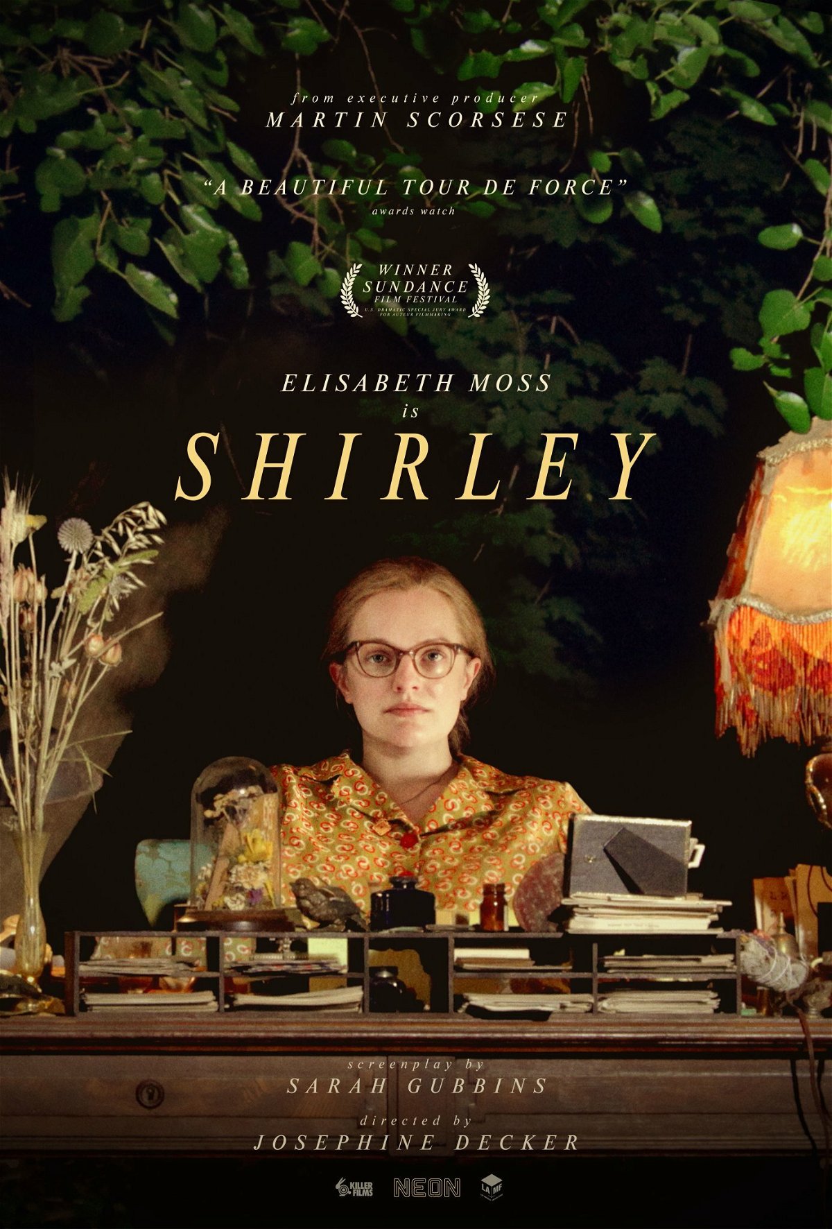 Elisabeth Moss seduta davanti a una scrivania nella locandina di Shirley