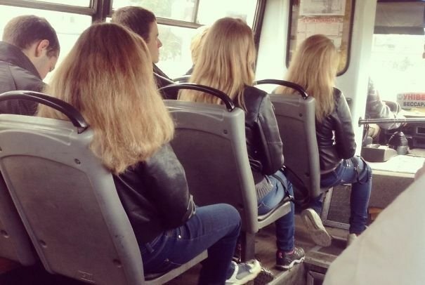 Glitch di Matrix: tre donne sedute in fila in autobus con lo stesso taglio e colore dei capelli e outfit