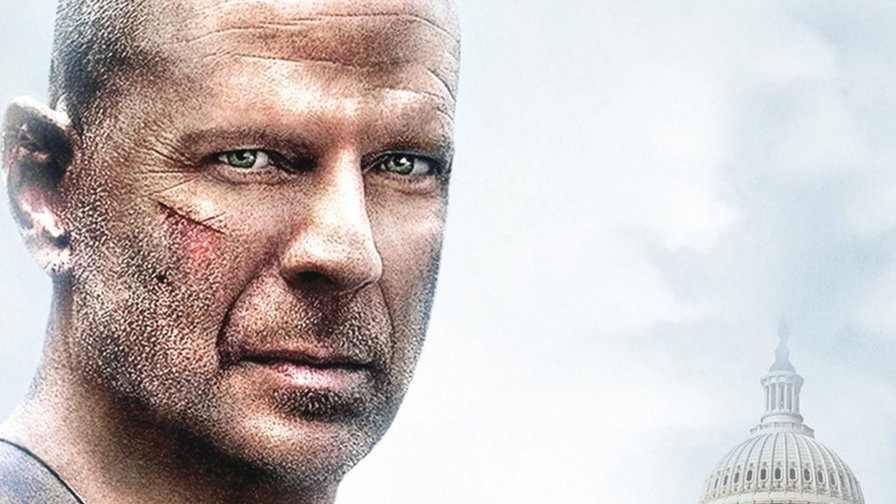 John McClane ferito in primo piano con il Campidoglio sullo sfondo